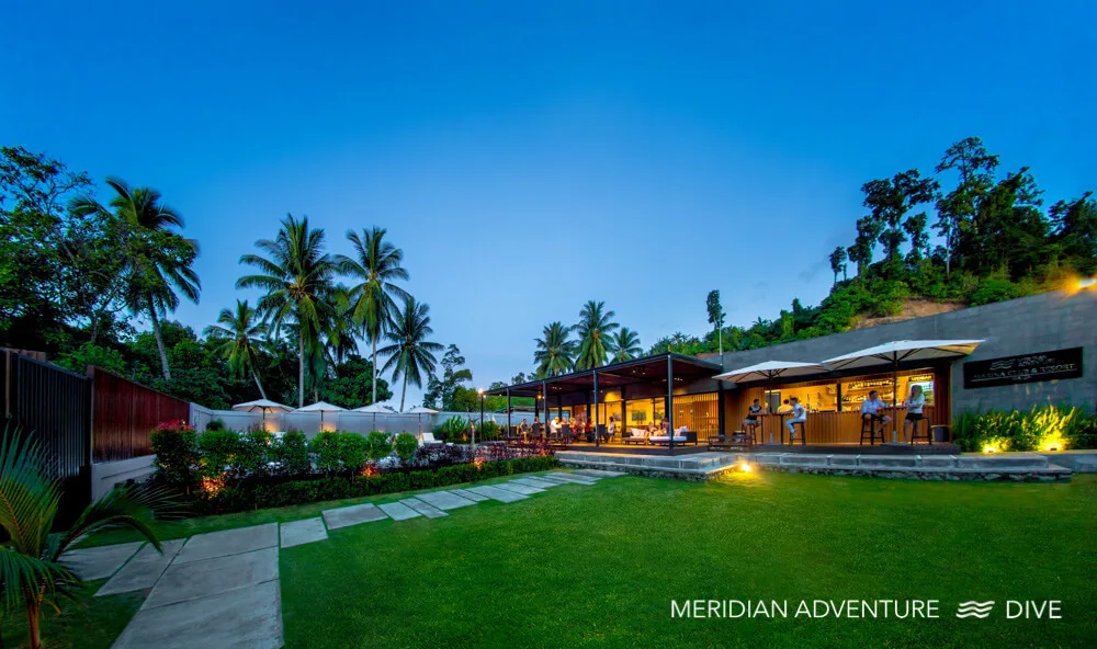 Meridian Adventure Dive resort and bar at dusk